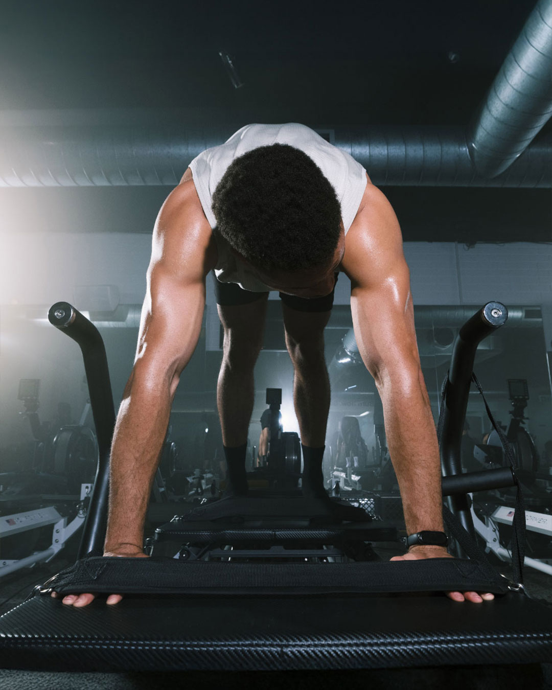 Member holding a plank on a reformer