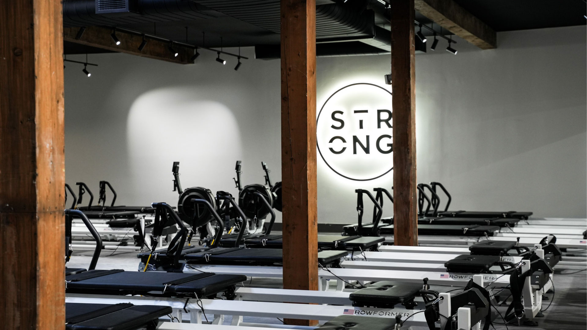 STRONG Pilates studio with rows of Rowformers and the STRONG logo